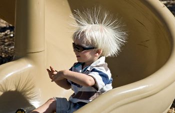 child on slide gaining charge of static electricity